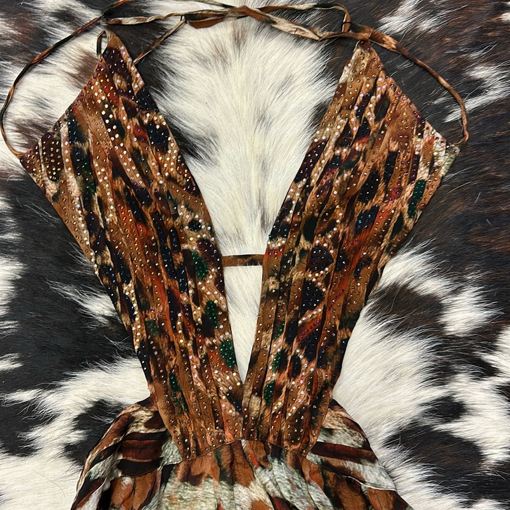 note there is a tear at the bottom off dress.  Very camouflaged by the print